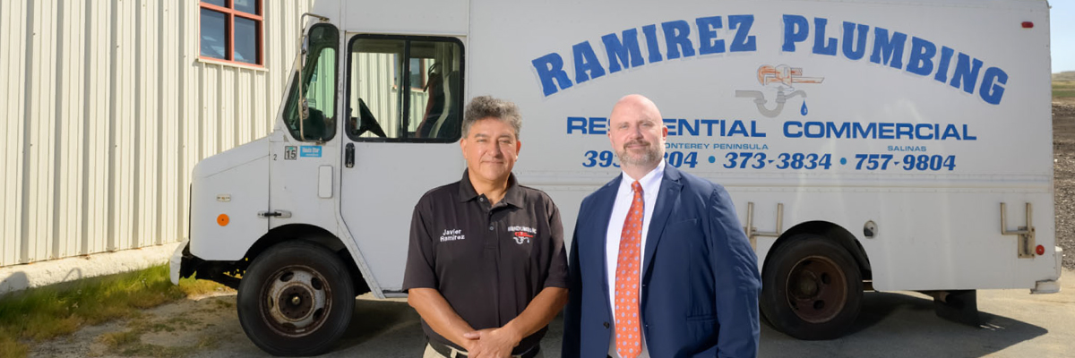 Owner in front of plumbing truck